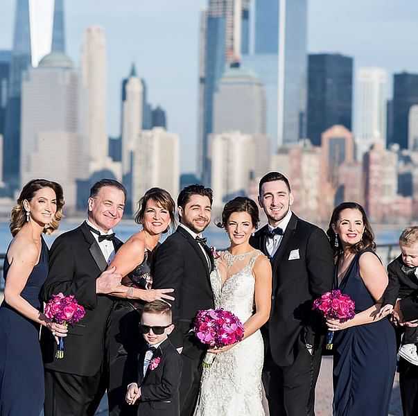 Wedding party posing with city skyline in the background.